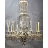 A William IV cut glass twelve light chandelier, with spiral fluted and facetted stem supporting a