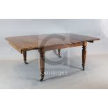 A large George IV mahogany extending dining table, the rounded rectangular top with six leaves, on