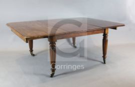 A large George IV mahogany extending dining table, the rounded rectangular top with six leaves, on