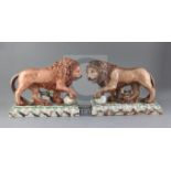 A near pair of Staffordshire pearlware figures of lions, c.1800-10, each resting a paw upon a spear,