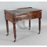 An early Victorian mahogany rectangular writing desk, with lifting central panel to the sloping top,