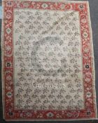 A Zeigler carpet, the ivory field with an all-over design of single floral sprigs, the madder border