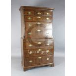 A George II walnut chest on chest, fitted three short, three graduated drawers over a slide and