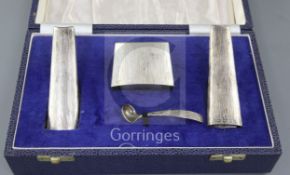 A stylish cased 1970's textured silver three piece condiment set and matching spoon by Mappin &