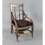 John Pollard Seddon (1827-1906). A rare Gothic oak armchair, with upright and horizontal splats to