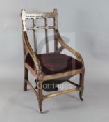 John Pollard Seddon (1827-1906). A rare Gothic oak armchair, with upright and horizontal splats to