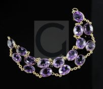 An attractive early to mid 20th century gold and twin row amethyst chain link bracelet, set with