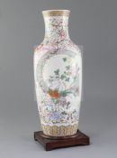 A Chinese famille rose baluster vase, painted with chrysanthemums amid rockwork, on a ground painted