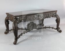 A 19th century Burmese hardwood centre or library table, with serpentine rectangular top and