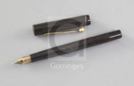 A Waterman's 'world's smallest' eyedropper 'doll' pen, in hard black rubber with gilt clip to the