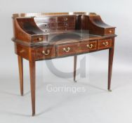 An Edwardian satinwood banded mahogany Carlton House desk, the raised superstructure fitted with