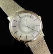 A gentleman's steel backed Longines manual wind wrist watch, with baton numerals, on an 18k gold
