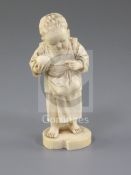 A Japanese ivory okimono of a boy holding a fruit, Tokyo School, Meiji period, 11.5cm