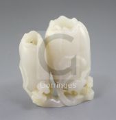 A Chinese white jade 'lotus' small vase, carved in high relief and open work with curled lotus