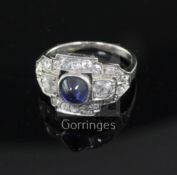 An Art Deco cabochon sapphire and diamond cluster ring, white metal setting (tests as 14ct), size K