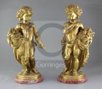 A pair of late 19th century French ormolu figures of putti, one holding a posy and basket of