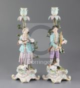 A pair of Meissen candlestick figures, late 19th century, each modelled as a musical shepherd and