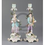 A pair of Meissen candlestick figures, late 19th century, each modelled as a musical shepherd and