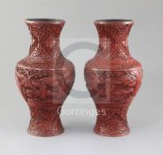 A pair of Chinese cinnabar lacquer baluster vases, 19th century, each carved in relief with