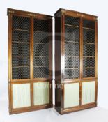 A suite of five Regency rosewood and brass mounted library bookcase cabinets, comprising a