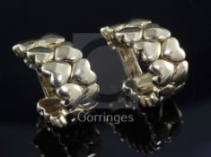 A pair of 18ct gold Cartier half hoop earrings, modelled as two rows of hearts, signed and