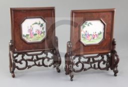 A pair of Chinese carved and pierced hardwood table screens, 19th century, inset with octagonal