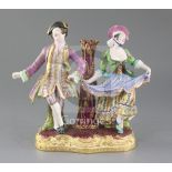 A Minton figure group candlestick. c.1840-5, modelled with a male and female dancer flanking a