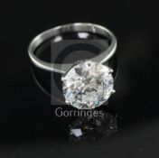 A platinum and solitaire diamond ring, with an old insurance valuation estimating the round