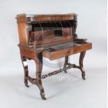 A George IV mahogany metamorphic writing desk, in the form of an upright pianoforte, with pierced