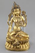 A Tibetan gilt bronze seated figure of Green Tara, seated on a double lotus throne, height 21.