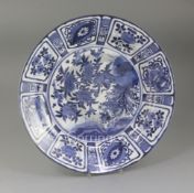 A Japanese Arita blue and white dish, c.1680-1700, the centre painted in Kraak style with geese amid