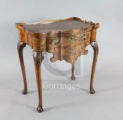 A late 18th century Dutch walnut and marquetry serpentine side table, with galleried top and two