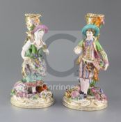 A pair of Minton candlestick figures, c.1835-36, modelled as male and female flower sellers, with