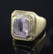 A 1970's high carat gold and amethyst? set Bishop's ring, the emerald cut stone in a stepped setting