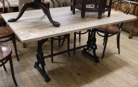 An Ash dining table with cast metal base 152 x 90cm