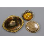 A painted oval panel in gilt metal mount, a yellow metal mourning brooch(a.f.) and an amber set