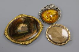 A painted oval panel in gilt metal mount, a yellow metal mourning brooch(a.f.) and an amber set