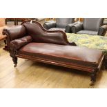 An early Victorian mahogany framed chaise longue, on reeded turned and tapering legs with brass feet