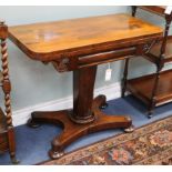 An early Victorian rosewood pedestal card table, with rectangular folding top, on octagonal tapering
