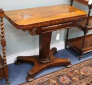 An early Victorian rosewood pedestal card table, with rectangular folding top, on octagonal tapering