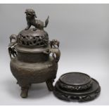 A large Chinese bronze tripod censer and cover and two wood stands censer height 42cm