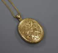 A Victorian engraved yellow metal oval locket, on a 9ct gold chain, locket 37mm.