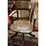 An early 20th century oak swivel desk chair