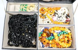 A quantity of costume jewellery including jet and amber.