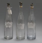 Three glass decanters, etched with Rhum, Kirsch and Cognac, with metal stoppers modelled as