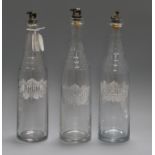 Three glass decanters, etched with Rhum, Kirsch and Cognac, with metal stoppers modelled as