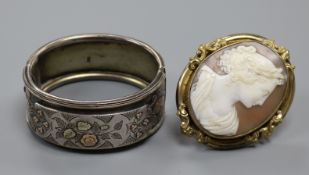 A Victorian carved shell cameo portrait brooch, gilt metal framed and a late Victorian silver bangle