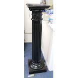 An ebonised statuary column, with rectangular top on Corinthian column support and rectangular base,