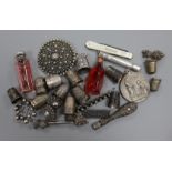 Assorted collectables including white metal brooches, silver thimbles and silver mounted scent