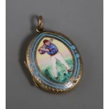 A late Victorian engraved yellow metal and enamel oval locket, decorated with a cricketer, 32mm.